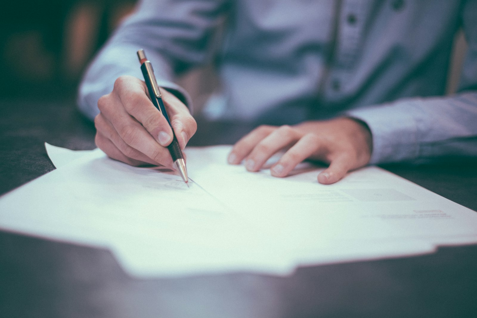 Homebuyers reviewing and signing closing documents at a title company